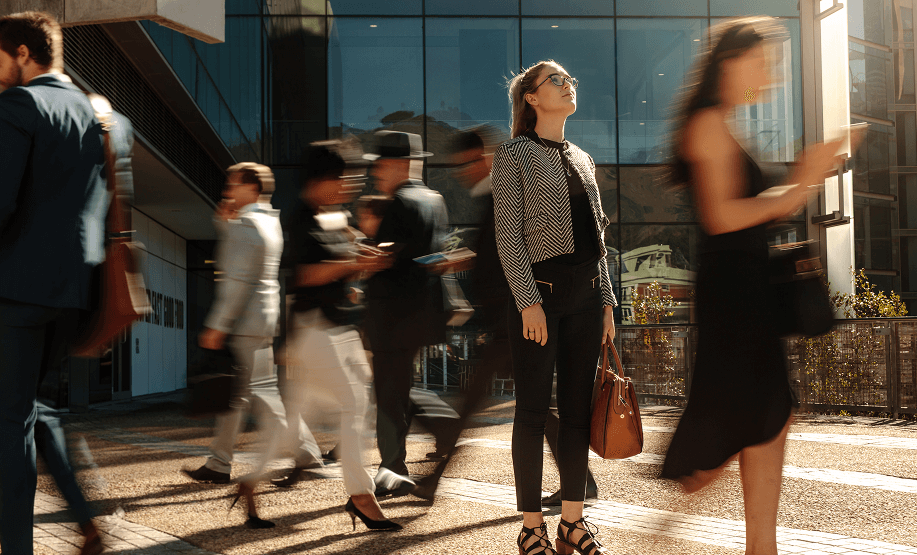 Business professional standing confidently in a busy city environment representing ICI's specialty insurance expertise.