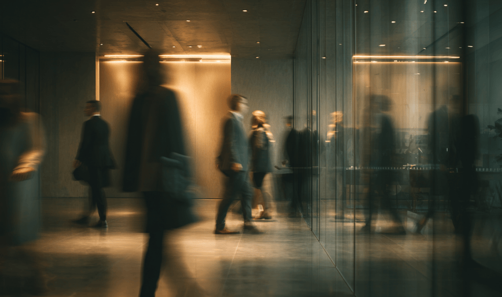 Business professionals moving through a corporate office building representing the specialty insurance industry.